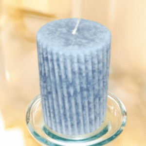 Styled Winter Wonderberry Candle on glass holder with warm background tones, showcasing ribbed spiral texture and hand-crafted holiday charm