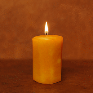 Butterscotch Candle – 14 oz Octagon Pillar hand-poured mottling paraffin lit in a cozy candlescape background
